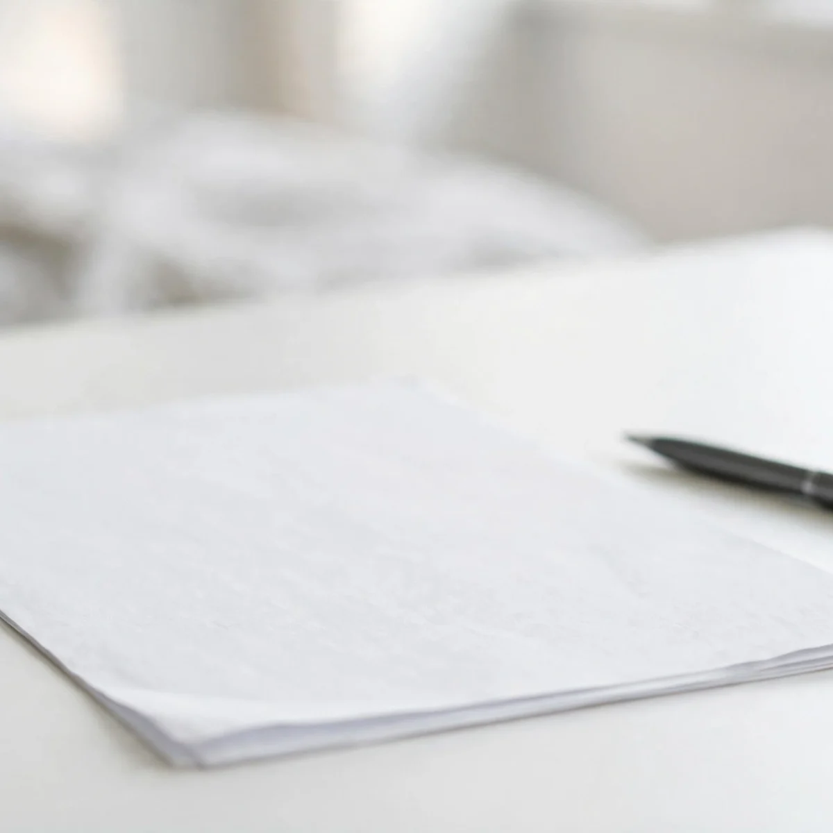 How to create an invoice: professional invoice document on a desk with pen