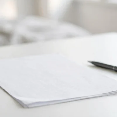 How to create an invoice: professional invoice document on a desk with pen
