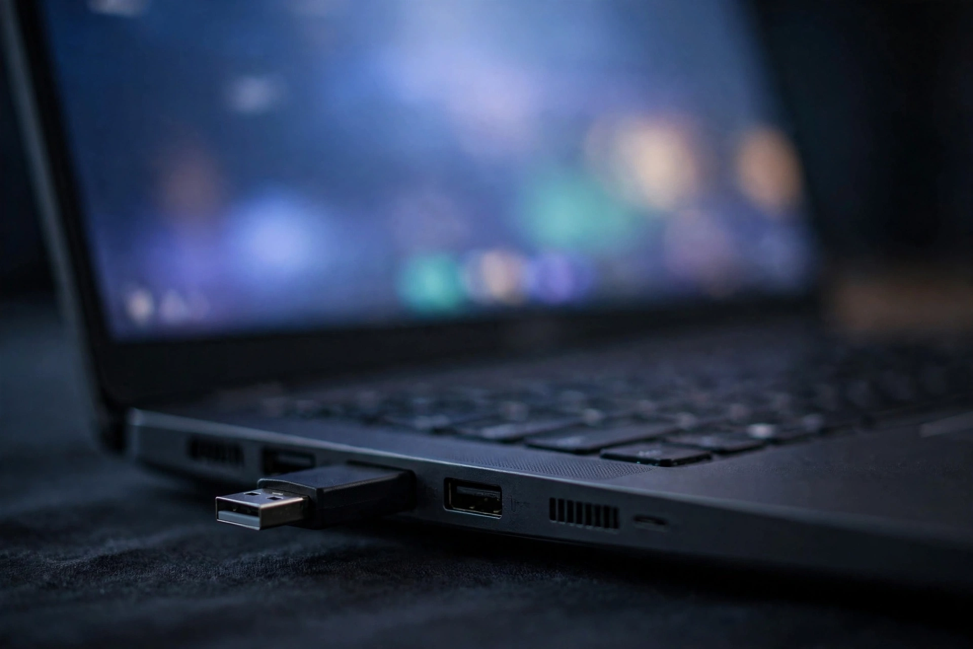 Bootable USB drive plugged into a laptop for Windows 11 installation