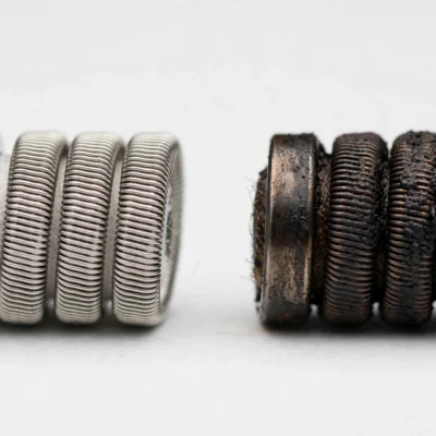 New vape coil compared with a worn used coil