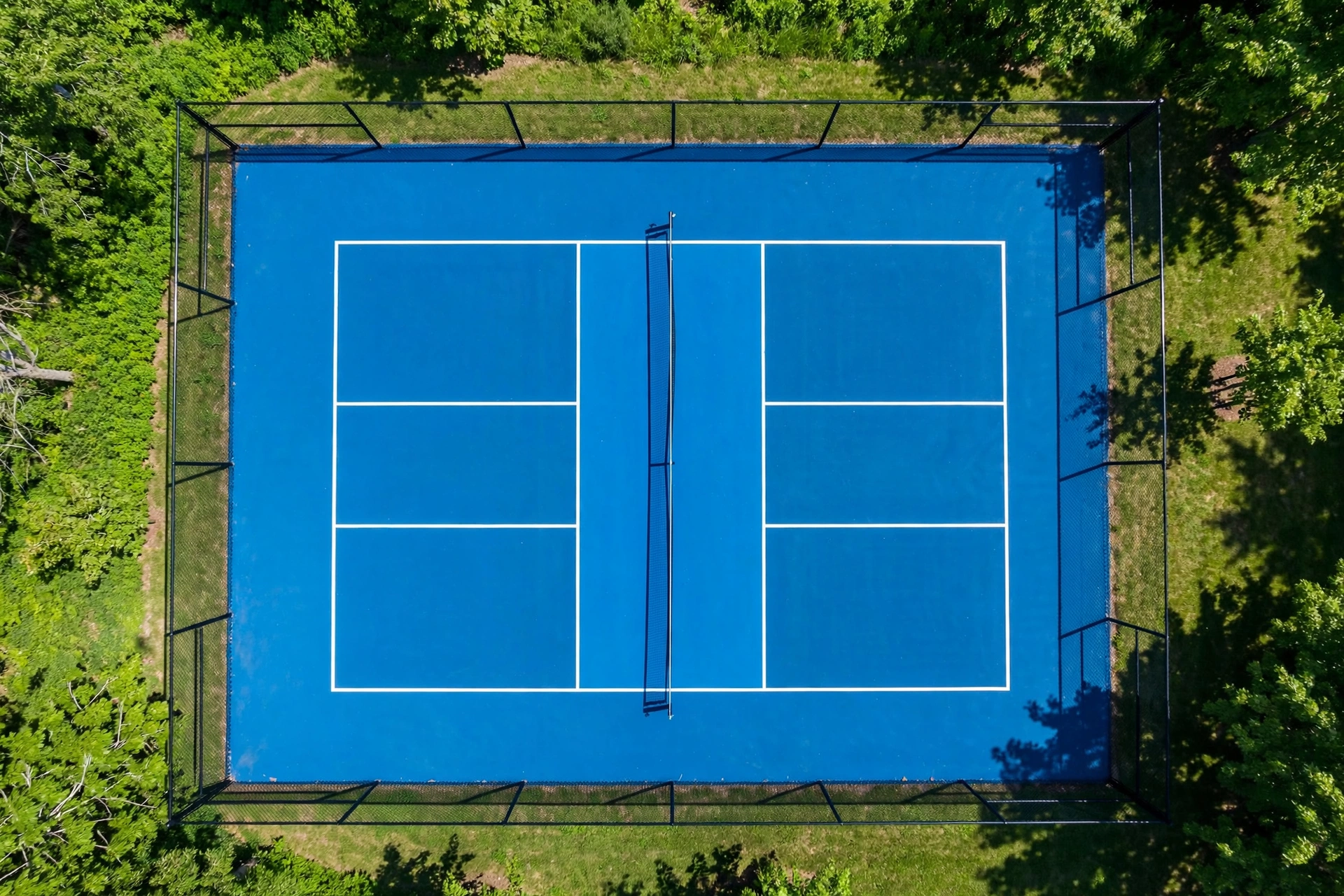 Aerial view of a pickleball court with line markings