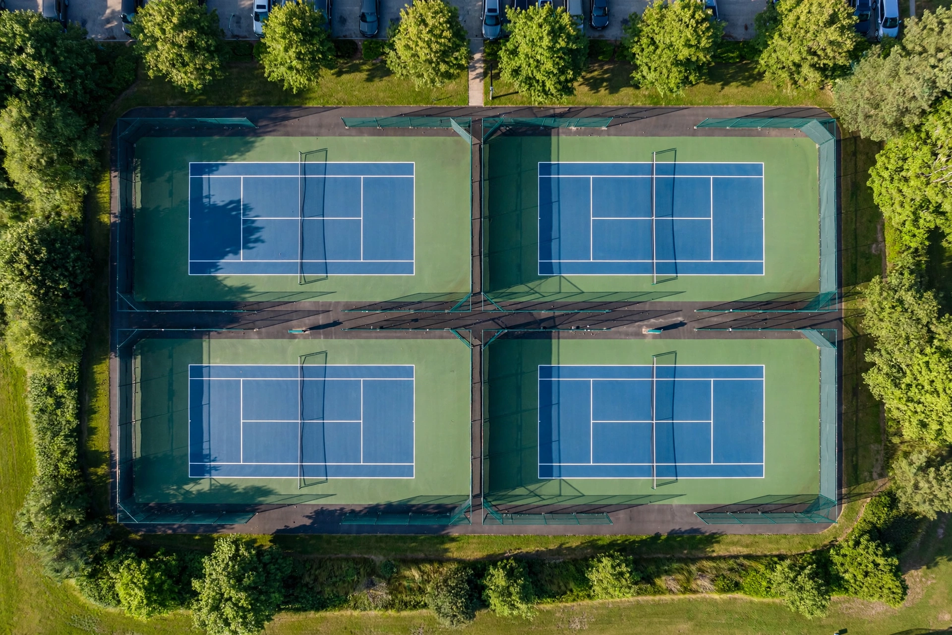 Aerial view of outdoor tennis courts showing court layout and dimensions